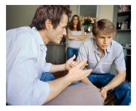 Photo of a father speaking to his son.